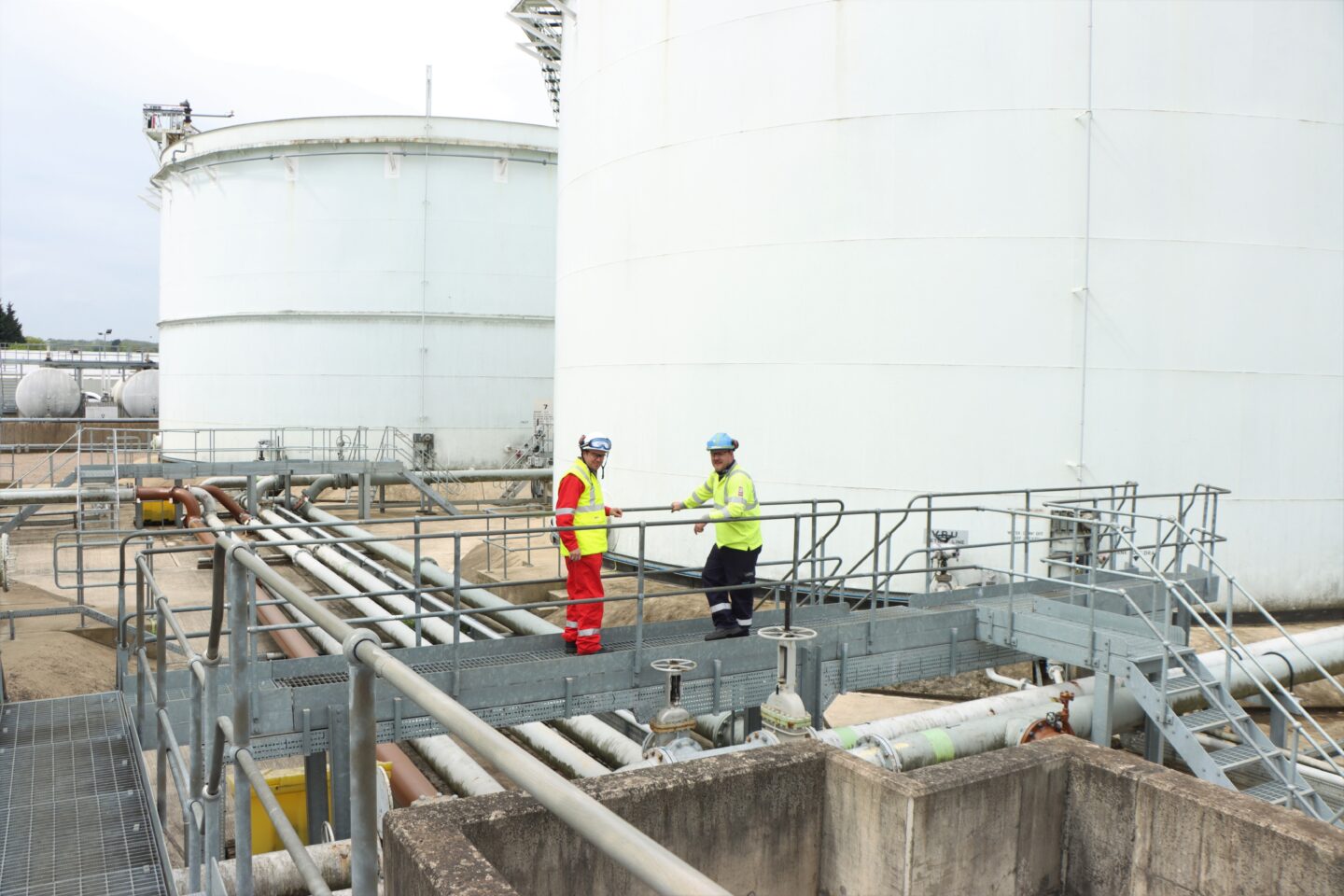 a photo of two crew members at the northampton oil terminal